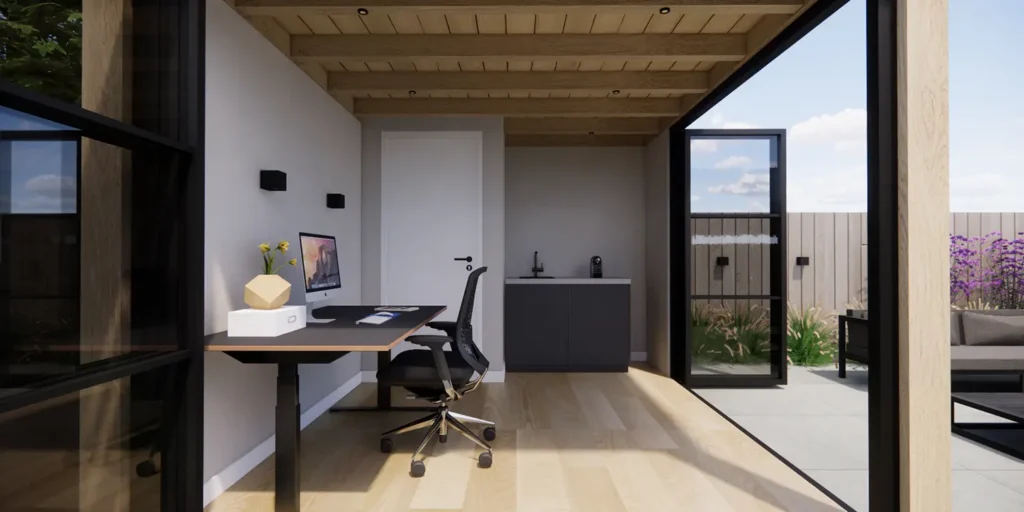 Binnenaanzicht van een tuinkantoor waarvan de deuren zijn opengezet, waardoor er een directe inloop is vanaf het tuinterras.